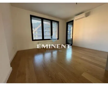 Empty room with hardwood floors and large windows. - image 6