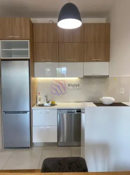 Small kitchen with wooden and white cabinets and built-in appliances. - image 2
