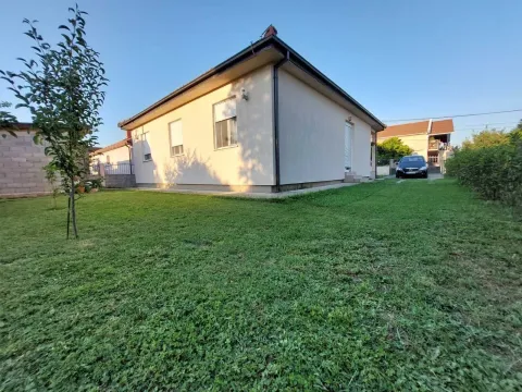 A single-story house with a green yard. - image 6