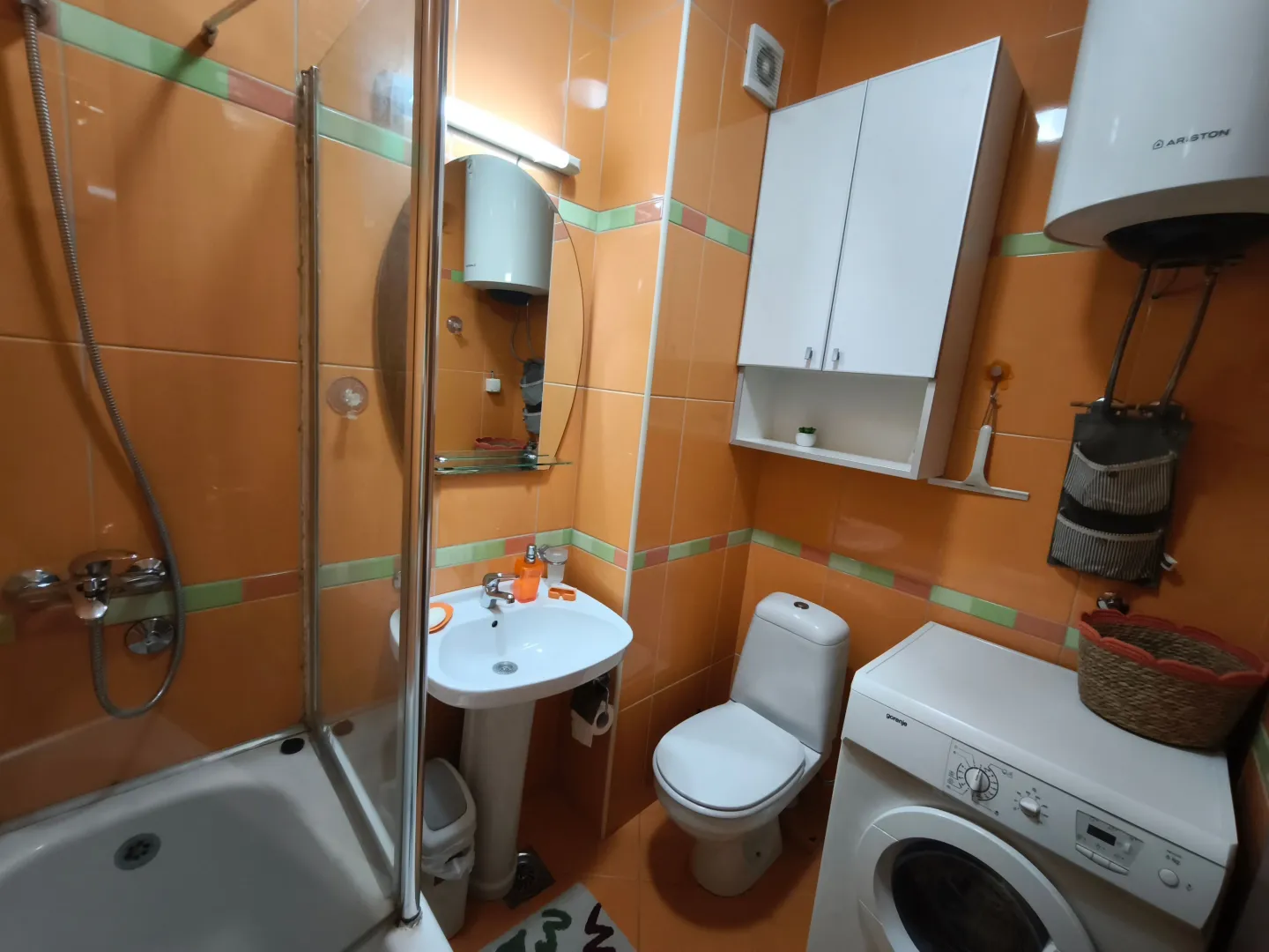 Kupatilo sa tuš kabinom, umivaonikom, WC šoljom i veš mašinom.