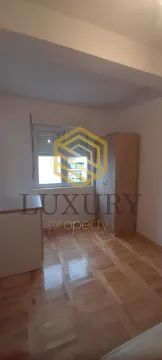 Empty bedroom with parquet flooring, window, and a wardrobe. - image 10