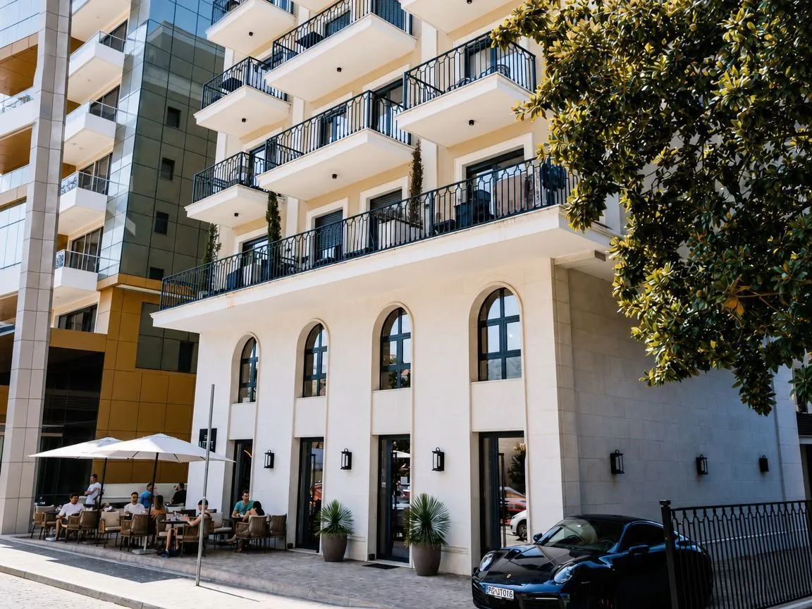 Exterior view of a multi-family building with balconies and a commercial space on the ground floor.