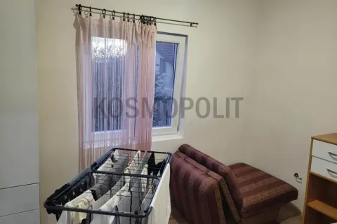 Smaller bedroom with a bed, a drying rack, and a window. - image 6