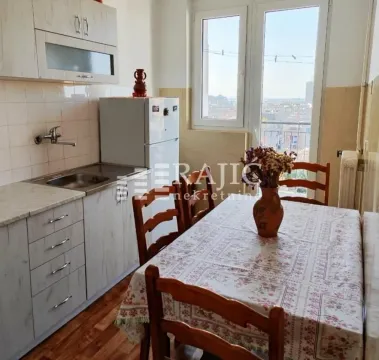 Small kitchen with a dining table and a window overlooking the city. - image 7