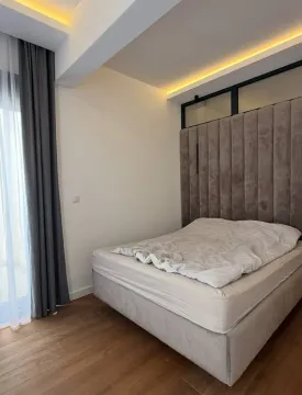 Modern bedroom with a double bed and upholstered headboard. - image 4