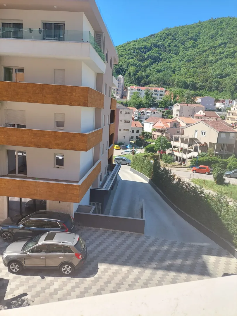 View from the terrace of the building, courtyard with parking, and the surrounding neighborhood.