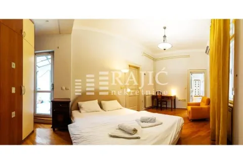 Spacious bedroom with a double bed, wardrobe, and desk. - image 6