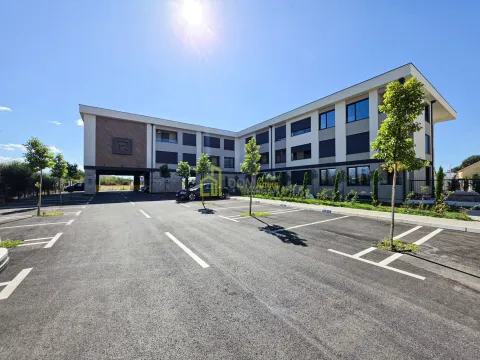 Exterior view of the building with parking space and landscaped greenery. - image 5