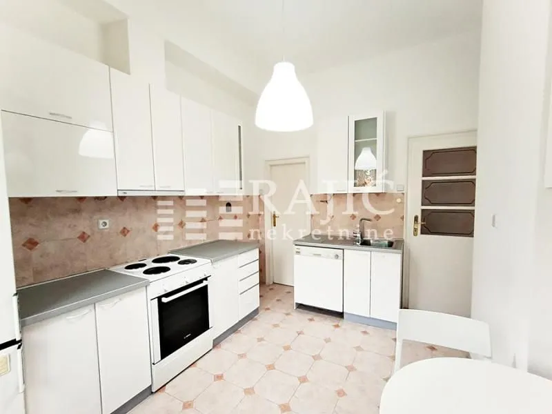 Bright kitchen with white cabinetry and a stove.