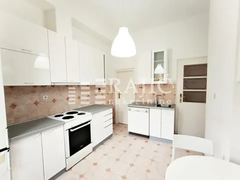 Bright kitchen with white cabinetry and a stove. - image 2