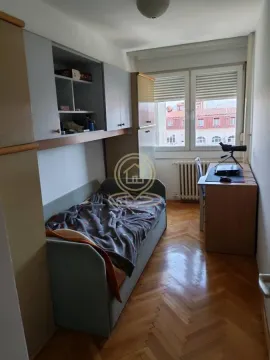 Children's bedroom with a bed, desk, and built-in storage units. - image 5