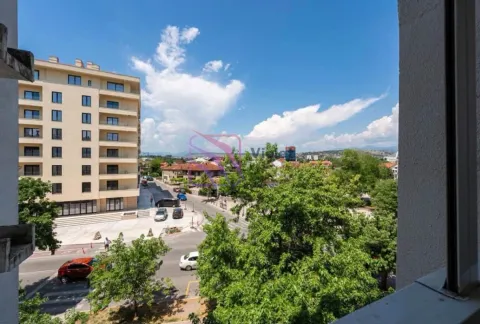 View from the window overlooking the city street and surrounding buildings. - image 5