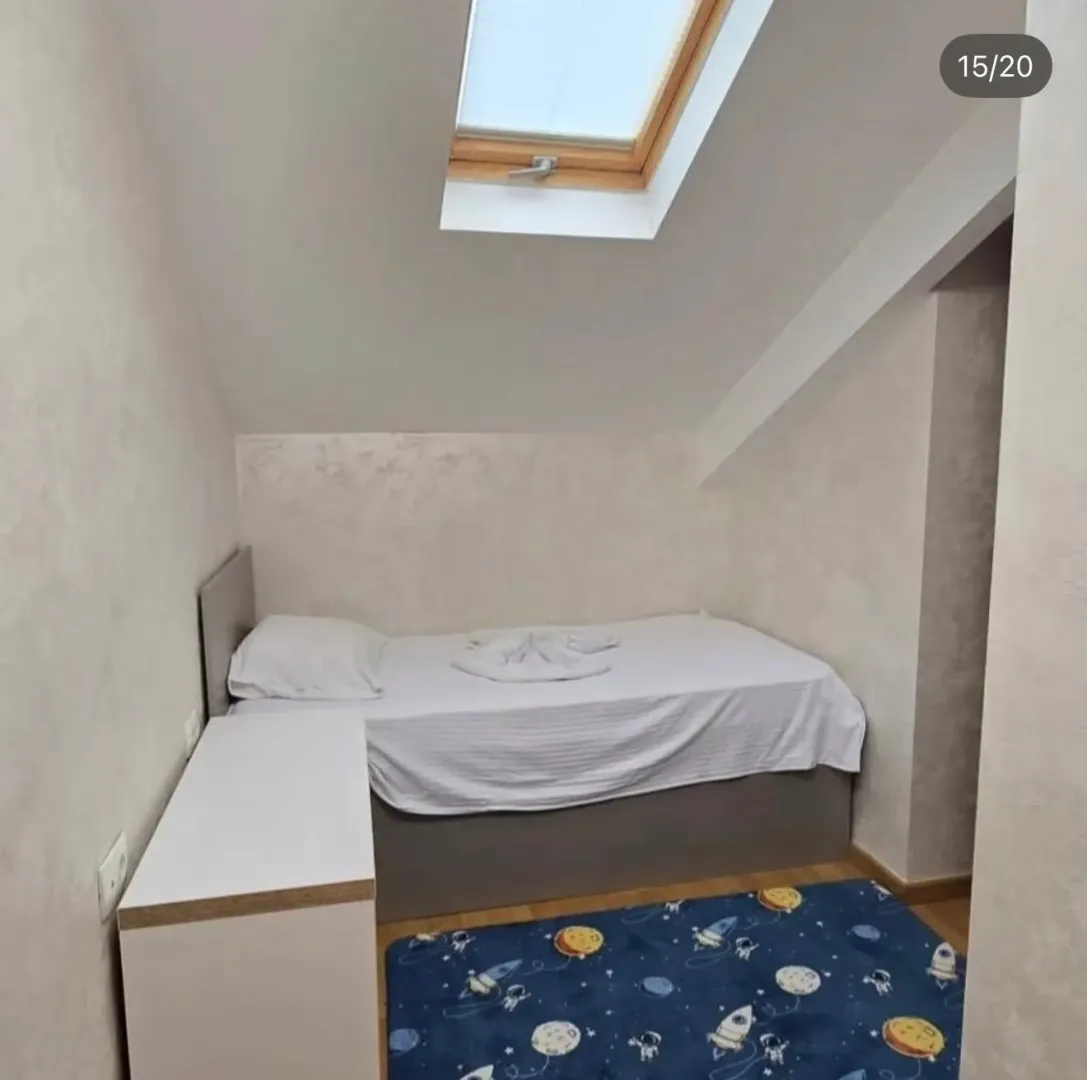 Attic bedroom with a bed and a roof window.
