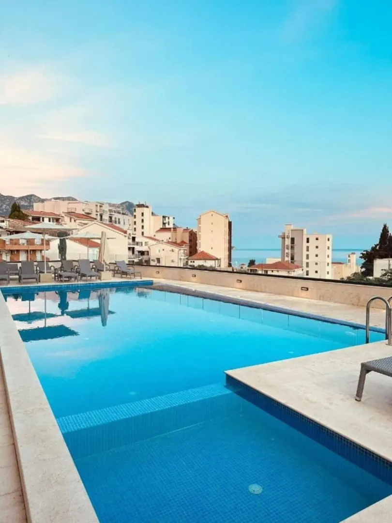 Rooftop swimming pool with city and sea views.