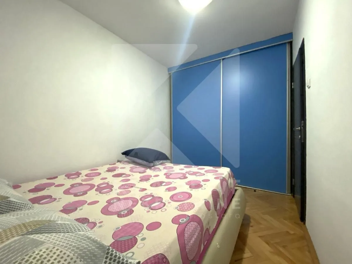 Bedroom with a bed and a blue fitted wardrobe.