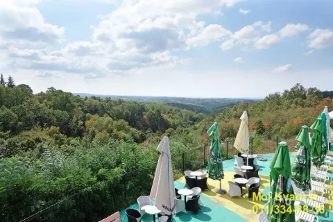 Large terrace with seating furniture and a view of nature and forest. - image 5