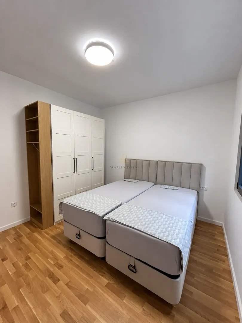 Bedroom with two beds and a wardrobe.