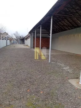 View of the yard with a canopy and outbuildings. - image 3