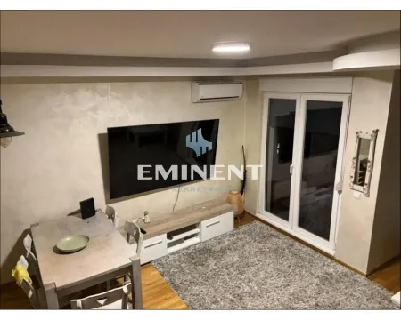 Living room with a dining table and a large wall-mounted TV. - image 2