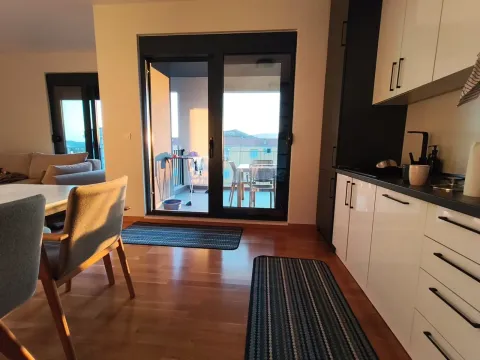 View of a modernly equipped kitchen with a dining area and access to the terrace. - image 6