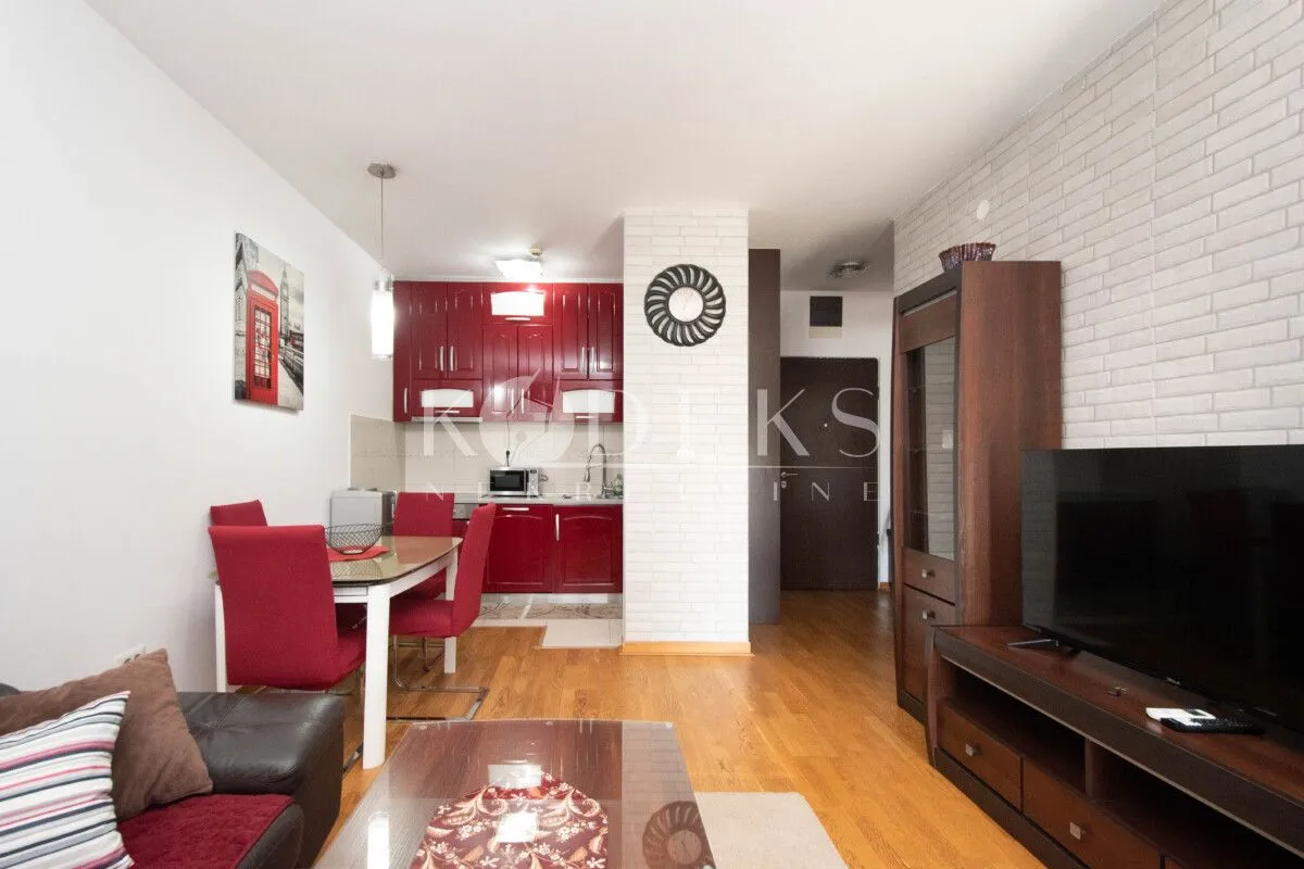 Living room with dining area and kitchen in the background.