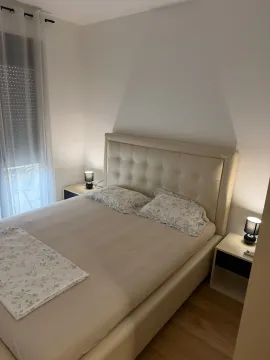 Furnished bedroom with a double bed and bedside tables. - image 6