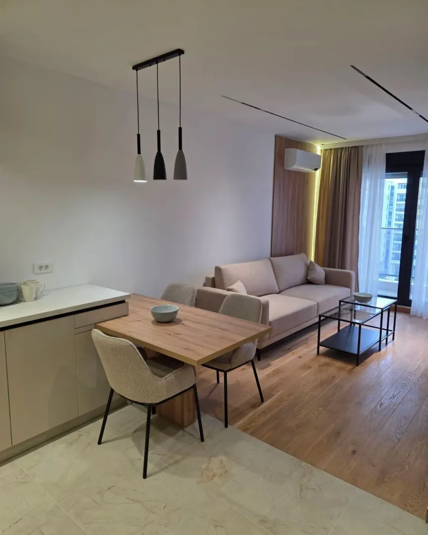 Modern living room with a dining area and sofa set.
