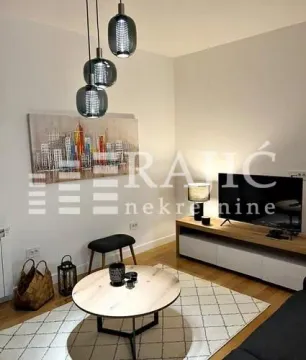 Modern living room with sofa, television and coffee table. - image 4