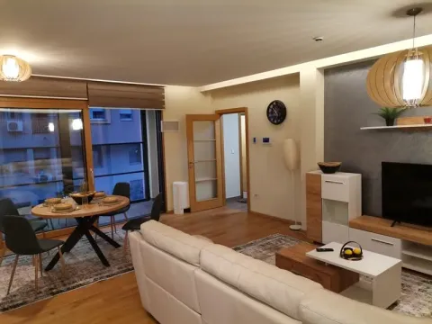 Spacious living room with a dining area, sofa set, and access to the terrace. - image 2
