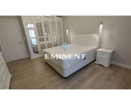 Bedroom with a large double bed, white wardrobe, and a nightstand. - image 10
