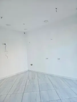 Empty room with white walls and a tiled floor. - image 3