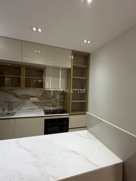 Modern kitchen with built-in cabinetry and a countertop. - image 9