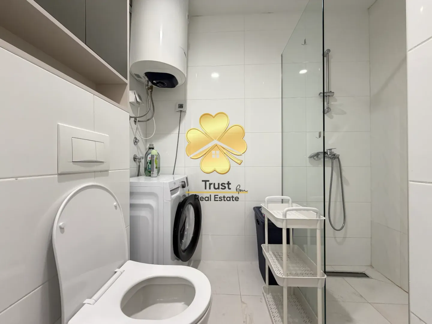 Brightly equipped bathroom with a walk-in shower, washing machine, and water heater.