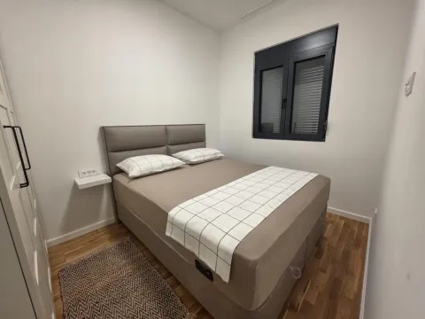Modern bedroom with a double bed and a window. - image 5