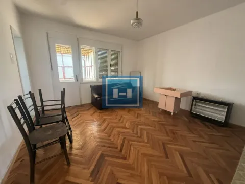 Empty room with wooden parquet flooring, chairs, and a small sink. - image 5