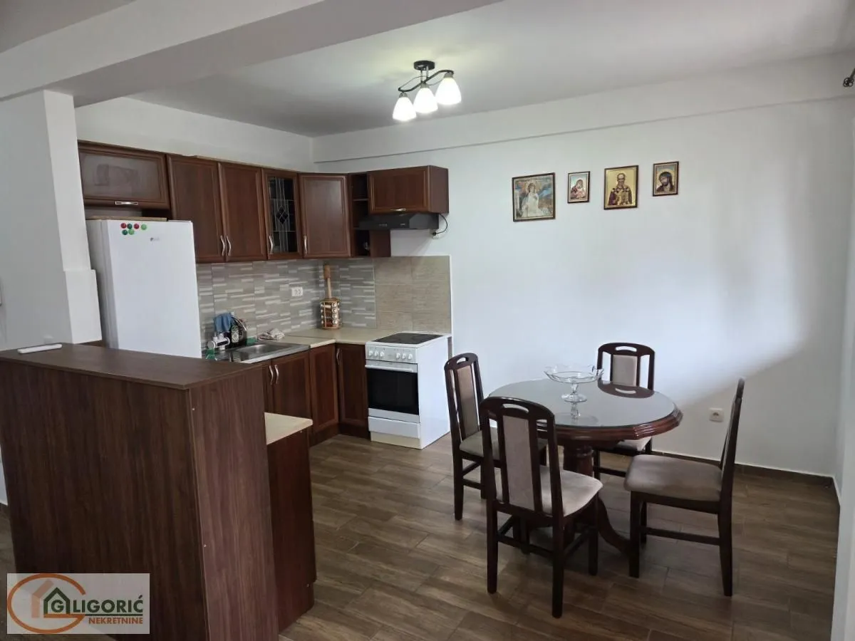 Kitchen with dining area equipped with wooden cabinets and a table with chairs.