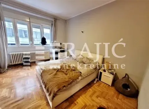Bedroom with a double bed and parquet flooring. - image 9