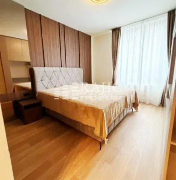 Modern bedroom with a double bed, wooden flooring, and wall panels. - image 5