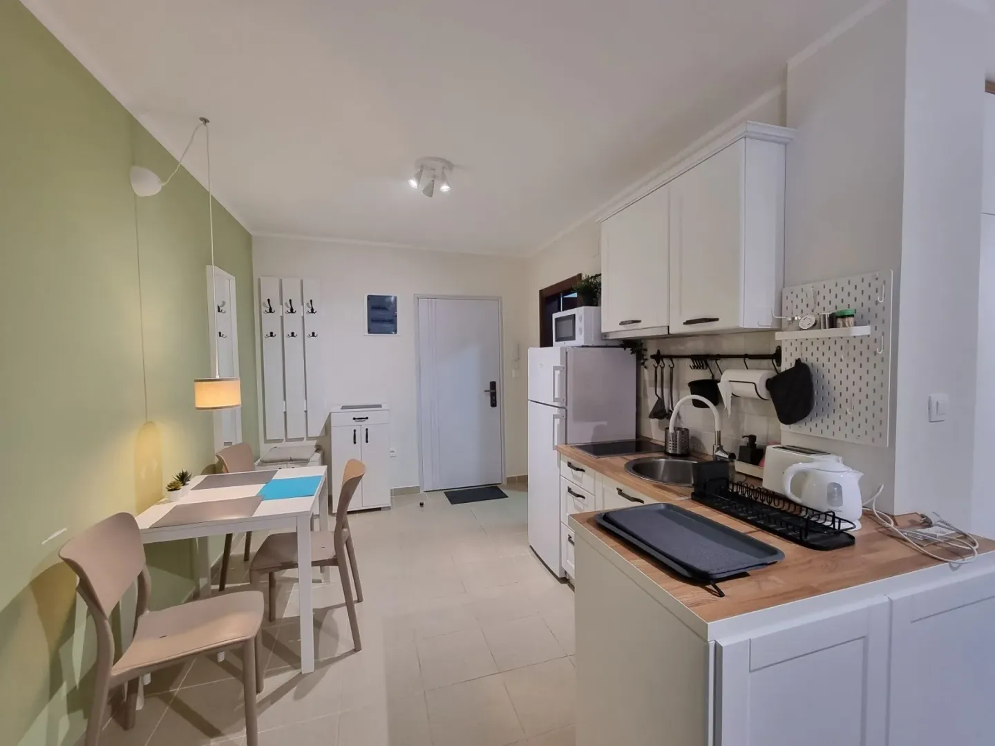 Kitchen with a dining area and white cabinetry.