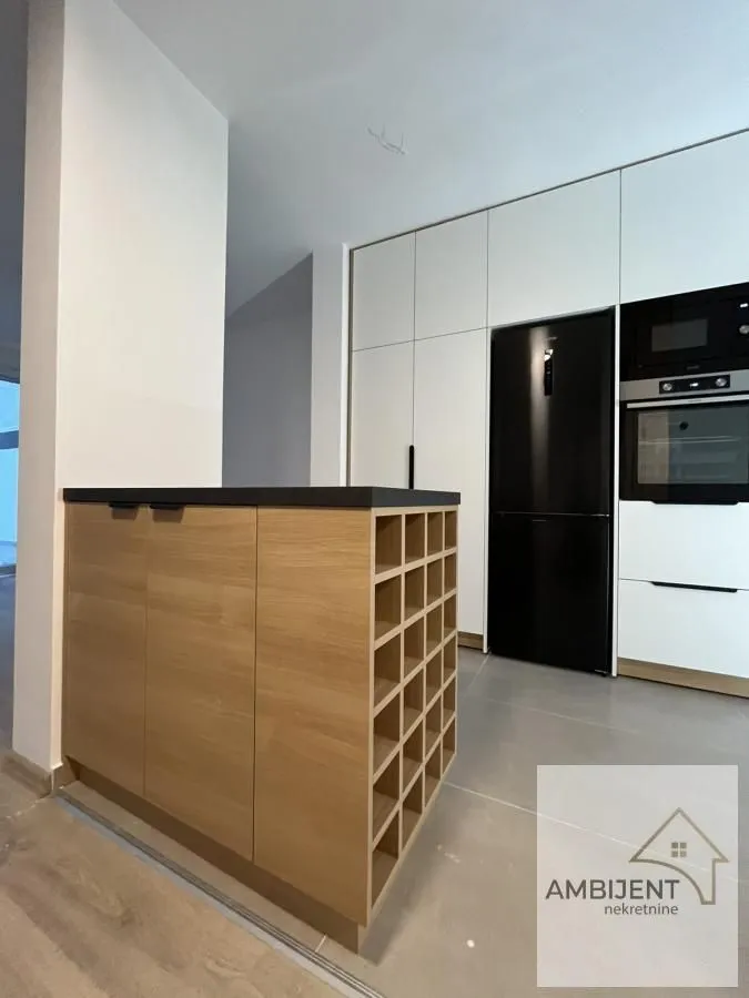 Modern kitchen with built-in appliances and a kitchen island.