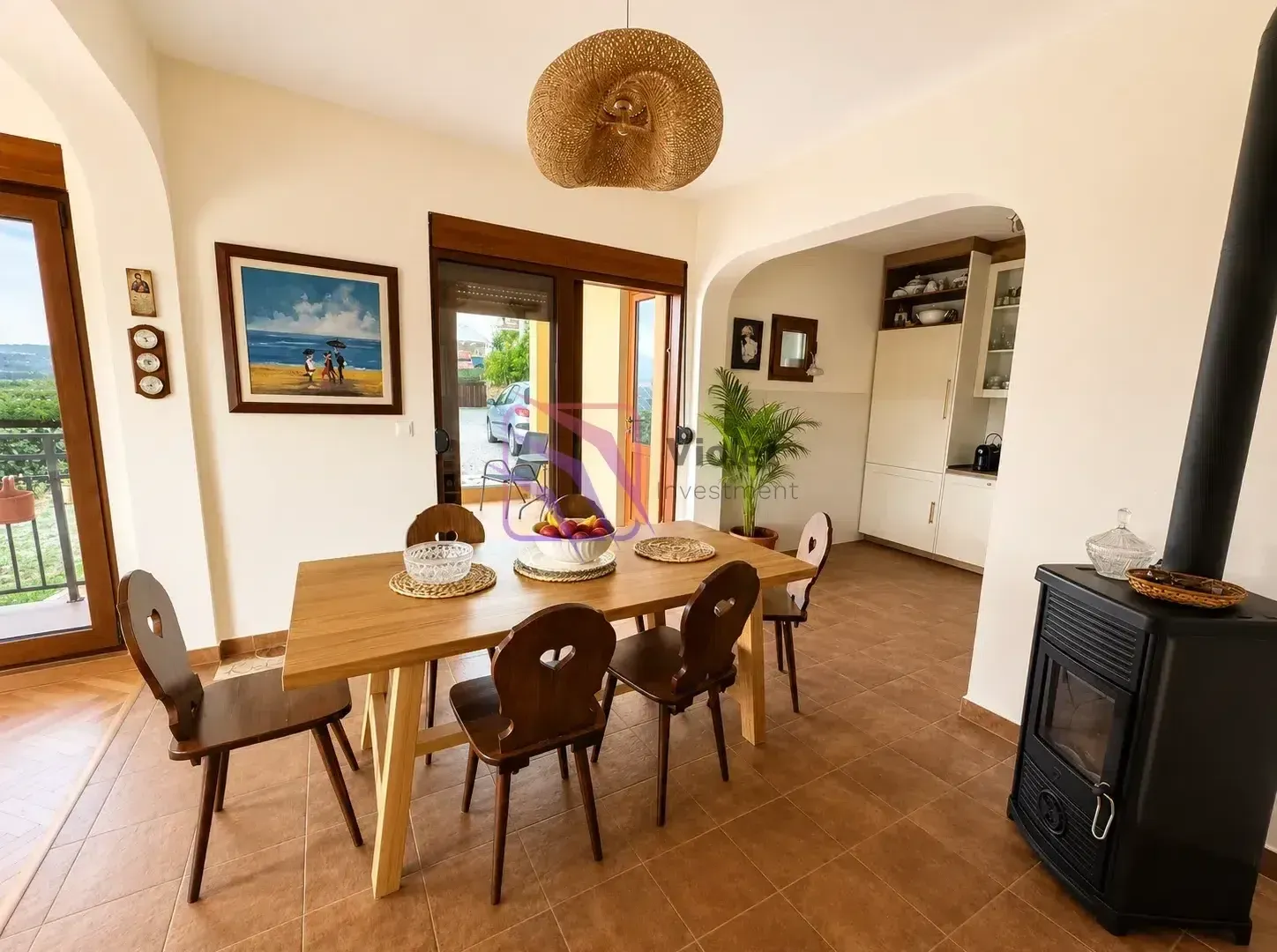 Dining area with a wooden table and a wood-burning stove.