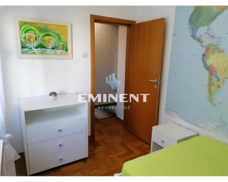 Furnished bedroom with a bed, chest of drawers, and a world map on the wall. - image 8