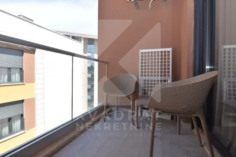 Small covered balcony with a glass railing and garden chairs. - image 14