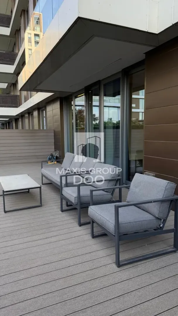 Spacious terrace with seating furniture and wooden flooring.