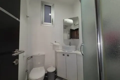 Small bathroom with a sink, toilet, and shower cabin. - image 9