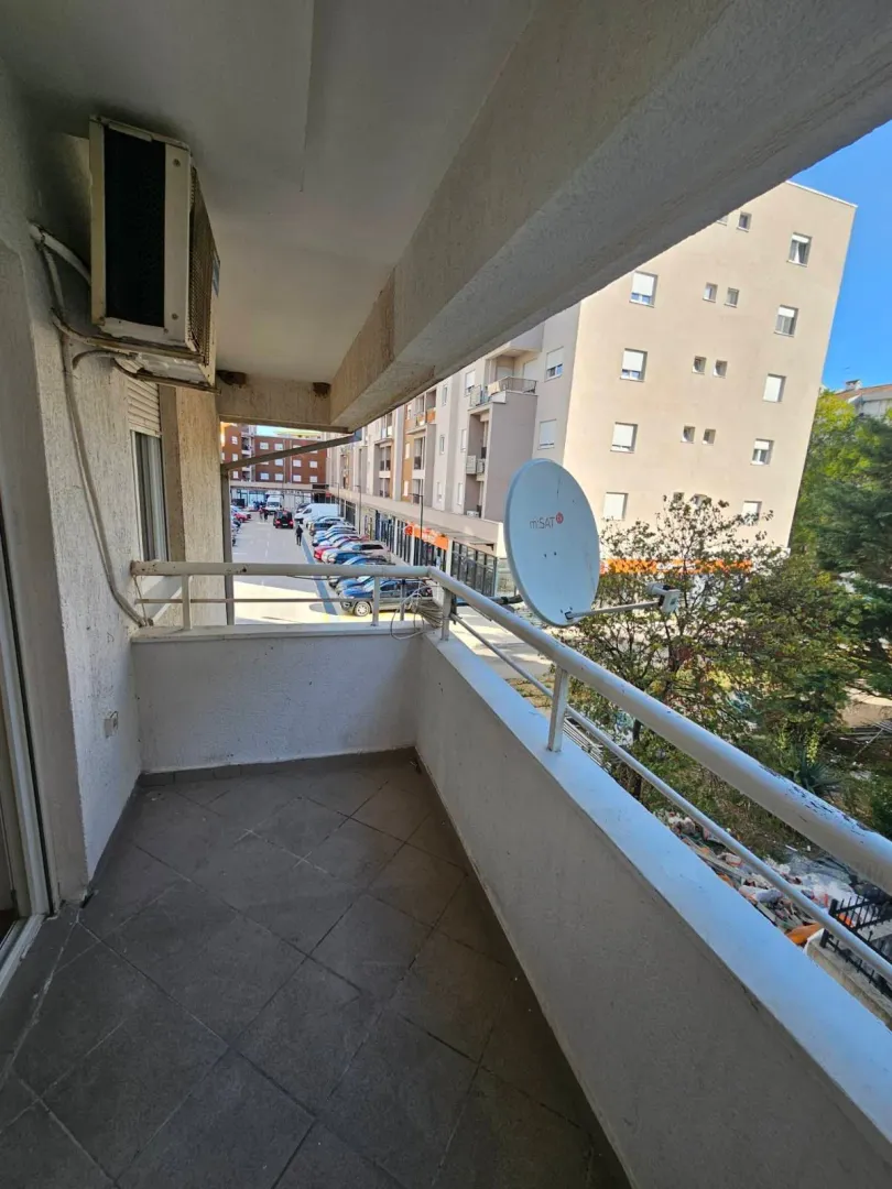 View from the balcony overlooking the street and surrounding buildings.