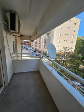 View from the balcony overlooking the street and surrounding buildings. - image 8