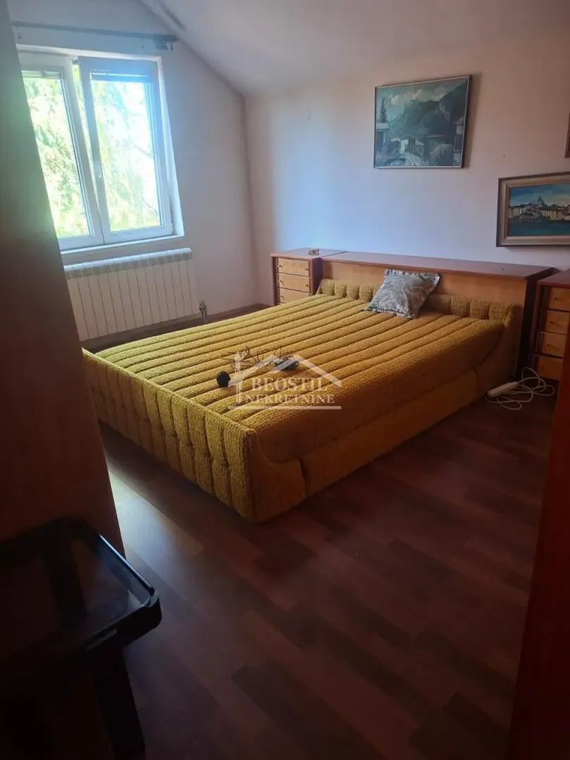 Bedroom with a double bed and a window.