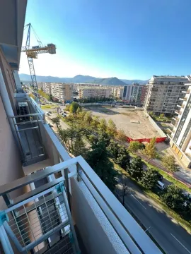 View from the balcony overlooking the city and surrounding buildings. - image 2