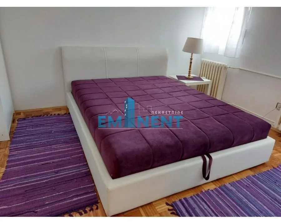 Bedroom with a double bed and a nightstand.